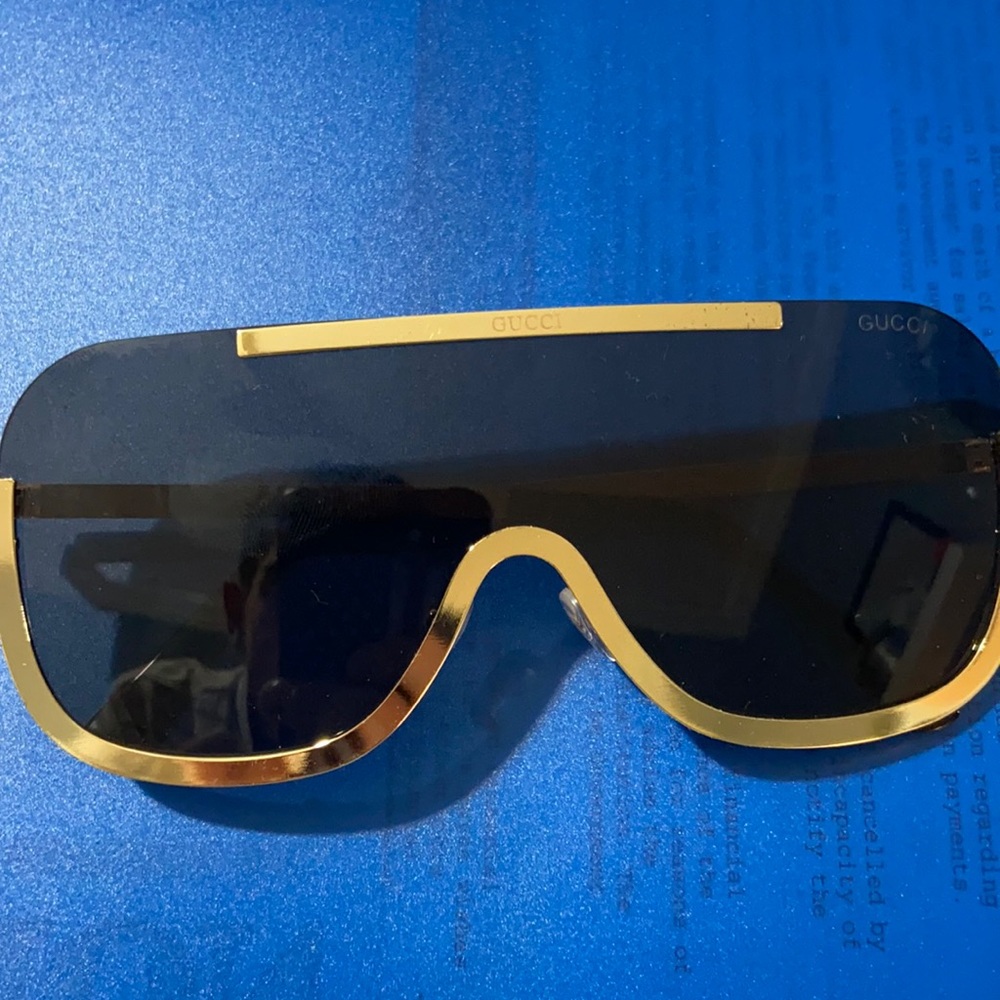 Gucci shield sunglasses gold and black metal frame